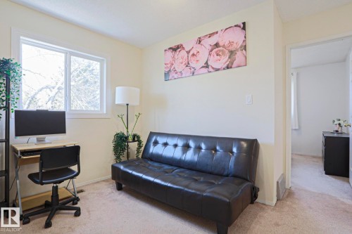Bright interior space featuring a window with natural light, light-colored walls, and carpet flooring - 2433 89 Street, Edmonton, AB - Indoor