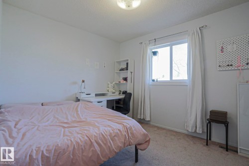 Carpeted room with a double window and white curtains - 2433 89 Street, Edmonton, AB - Indoor Photo Showing Bedroom