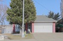 Brick facade home featuring an attached two-car garage, a covered front entry, and a mature evergreen tree - 2433 89 Street, Edmonton, AB  - Outdoor 