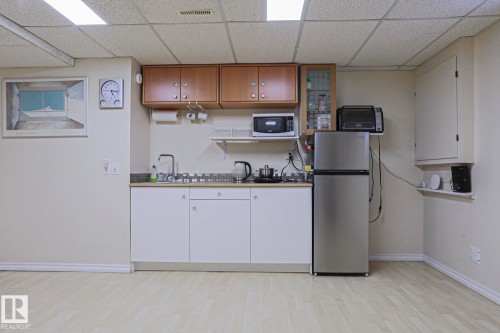 Compact kitchenette featuring wood-finish flooring and a drop ceiling - 2433 89 Street, Edmonton, AB - Indoor Photo Showing Other Room