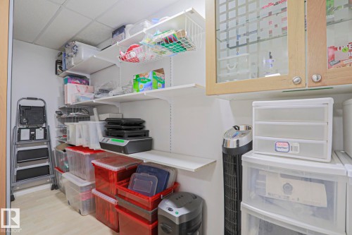 Storage area with light wood-finish flooring, white walls, and a drop ceiling - 2433 89 Street, Edmonton, AB - Indoor