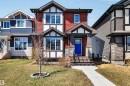 Red siding exterior featuring stone accents and white trim - 2424 Wonnacott Crest, Edmonton, AB  - Outdoor With Facade 