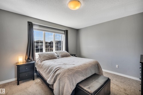Bedroom featuring neutral gray walls and light-colored carpeting - 2424 Wonnacott Crest, Edmonton, AB - Indoor Photo Showing Bedroom