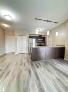 Open-concept living area featuring light wood-finish flooring - 