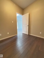Warm neutral wall tones with wood-finish flooring - 