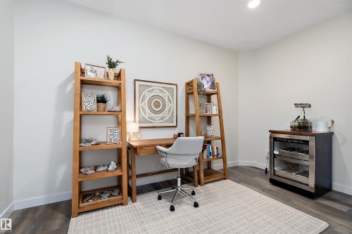 Bright room featuring wood-finish flooring, recessed lighting, and white baseboards - 591 Boulder Wynd, Leduc, AB - Indoor Photo Showing Office