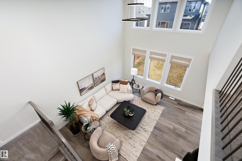 Two-story living area with high ceilings and wood-finish flooring - 591 Boulder Wynd, Leduc, AB - Indoor