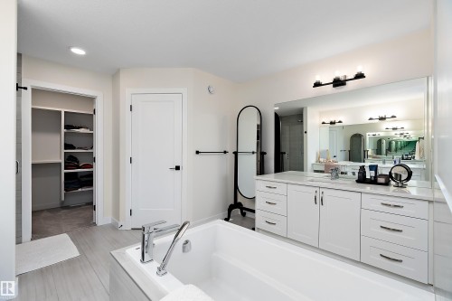 White vanity with a single basin, extensive countertop space, and undermount storage - 591 Boulder Wynd, Leduc, AB - Indoor Photo Showing Bathroom
