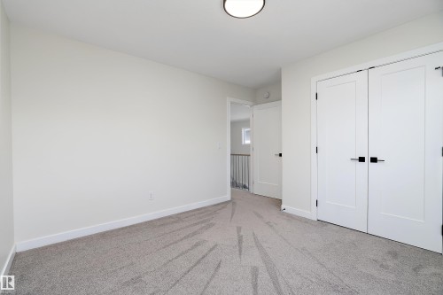 Carpeted interior space featuring white walls and white trim - 591 Boulder Wynd, Leduc, AB - Indoor Photo Showing Other Room