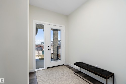 Entryway featuring a full-light door with a sidelight, dark wood-finish flooring, and light wall paint - 591 Boulder Wynd, Leduc, AB - Indoor Photo Showing Other Room