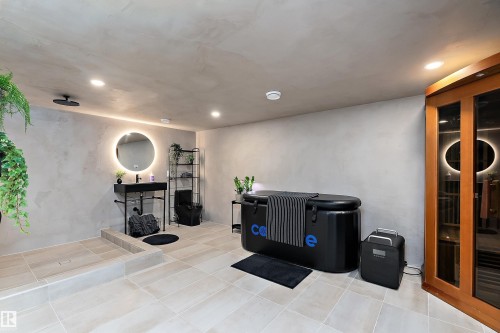 Contemporary room featuring light-toned tiled flooring and textured wall finishes - 591 Boulder Wynd, Leduc, AB - Indoor