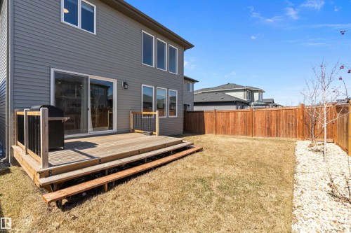 Rear exterior featuring grey horizontal siding and multiple windows - 591 Boulder Wynd, Leduc, AB - Outdoor With Deck Patio Veranda With Exterior