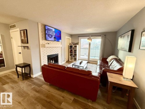 205 60 Alpine Place, St. Albert, AB - Indoor Photo Showing Living Room With Fireplace
