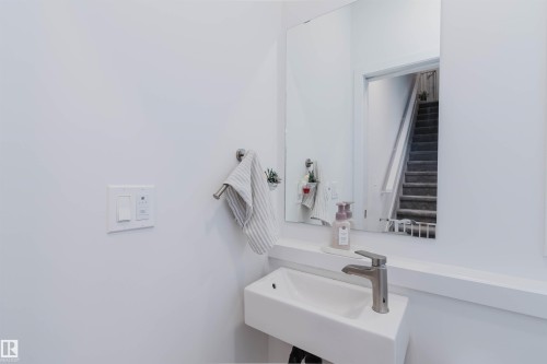 White wall-mounted rectangular sink with a brushed nickel single-lever faucet - 3288 Keswick Way, Edmonton, AB - Indoor Photo Showing Bathroom
