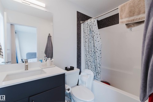 Bathroom with a built-in white bathtub and shower combination - 3288 Keswick Way, Edmonton, AB - Indoor Photo Showing Bathroom