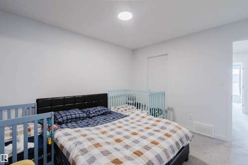 Carpeted room featuring white painted walls and a flush-mount ceiling light - 3288 Keswick Way, Edmonton, AB - Indoor Photo Showing Bedroom