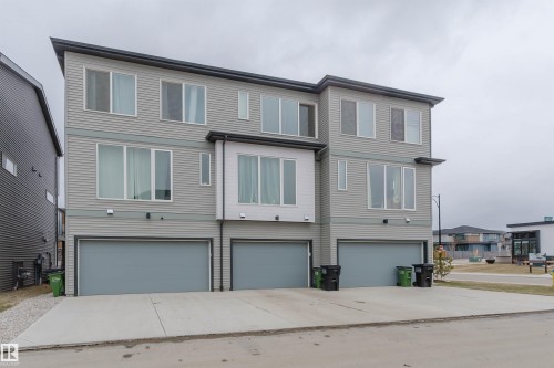 Modern multi-level townhome featuring horizontal siding in light gray with white trim - 3288 Keswick Way, Edmonton, AB - Outdoor