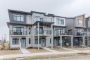 Modern townhome exterior featuring multi-toned siding, a flat roofline, and multiple balconies with dark-framed railings - 3288 Keswick Way, Edmonton, AB  - Outdoor With Balcony With Facade 