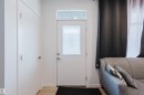 Entryway with a white door featuring a frosted glass panel and transom window - 3288 Keswick Way, Edmonton, AB  - Indoor Photo Showing Other Room 