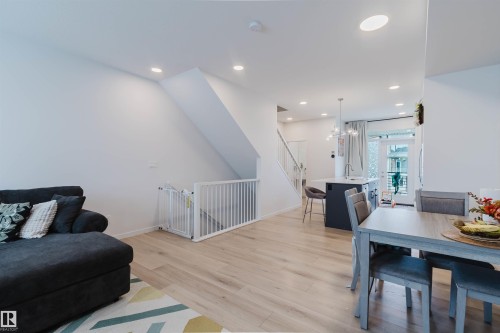 Open-concept living space with light wood-finish flooring - 3288 Keswick Way, Edmonton, AB - Indoor