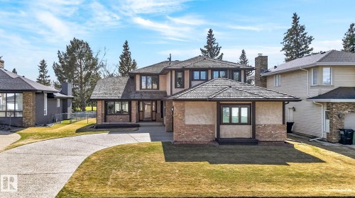 Two-story residence featuring a shingle roof, stone and stucco exterior, and multiple windows with dark trim - 848 Wheeler Road W, Edmonton, AB - Outdoor With Facade