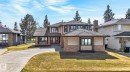 Two-story residence featuring a shingle roof, stone and stucco exterior, and multiple windows with dark trim - 848 Wheeler Road W, Edmonton, AB  - Outdoor With Facade 