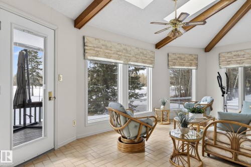 Sunroom with exposed wood beams, skylights, and multiple windows - 848 Wheeler Road W, Edmonton, AB - Indoor Photo Showing Living Room