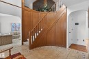 Curved wood-paneled staircase with carpeted treads - 848 Wheeler Road W, Edmonton, AB  - Indoor Photo Showing Other Room 