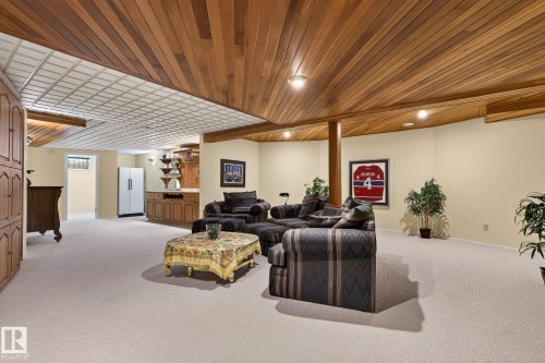 Finished lower level featuring a wood-panel ceiling, recessed lighting, and light-toned carpeting - 848 Wheeler Road W, Edmonton, AB - Indoor