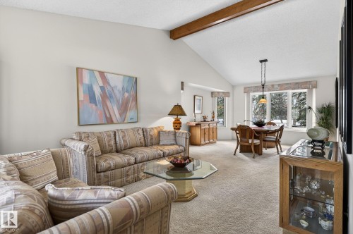 Vaulted ceiling with exposed wood beam and textured finish - 848 Wheeler Road W, Edmonton, AB - Indoor Photo Showing Living Room
