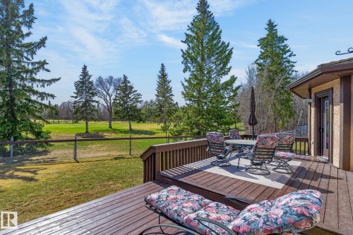Expansive wood-finish decking featuring a dining area and direct exterior access - 848 Wheeler Road W, Edmonton, AB - Outdoor With Deck Patio Veranda