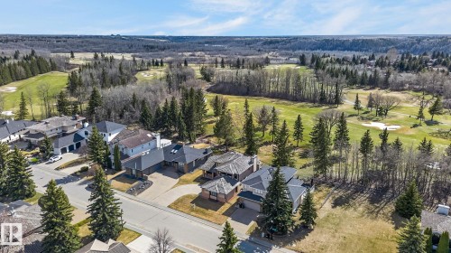 Aerial perspective showcasing residential properties bordering a golf course - 848 Wheeler Road W, Edmonton, AB - Outdoor With View