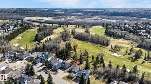 Aerial perspective highlighting a residential property situated alongside a golf course, surrounded by mature trees and natural landscapes - 848 Wheeler Road W, Edmonton, AB - Outdoor With View