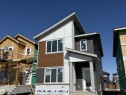 Contemporary exterior featuring multi-toned siding, a prominent covered entry, multiple large windows, and a distinctive roofline - 45 River Birch, St. Albert, AB  - Outdoor 