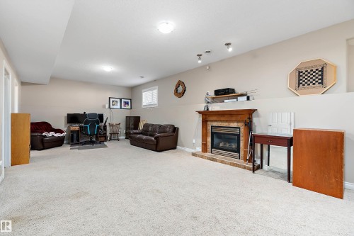 28 Woods Place, Leduc, AB - Indoor Photo Showing Other Room With Fireplace