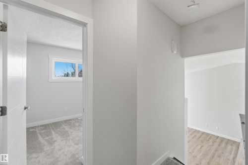 Contemporary interior featuring white walls and trim, with a modern door and silver hardware - 119 Dorchester Drive, St. Albert, AB - Indoor Photo Showing Other Room