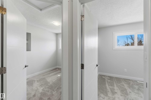 Two rooms featuring light gray walls, textured ceilings, and patterned carpeting - 119 Dorchester Drive, St. Albert, AB - Indoor Photo Showing Other Room