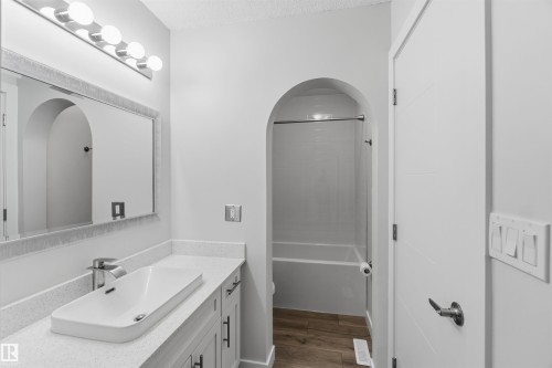 Bathroom featuring a vanity with quartz countertop, a rectangular vessel sink, and a chrome waterfall faucet - 119 Dorchester Drive, St. Albert, AB - Indoor Photo Showing Bathroom