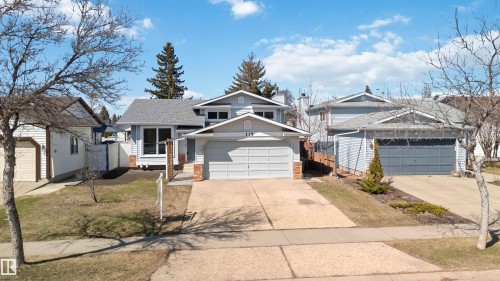 Siding exterior featuring a double-car garage and brick accents - 119 Dorchester Drive, St. Albert, AB - Outdoor With Facade