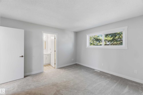 Spacious room featuring gray carpet flooring, light gray walls, and white trim throughout - 119 Dorchester Drive, St. Albert, AB - Indoor Photo Showing Other Room