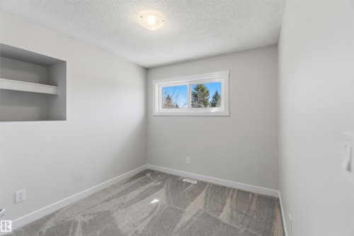 Neutral gray walls complementing gray patterned carpet - 119 Dorchester Drive, St. Albert, AB - Indoor Photo Showing Other Room