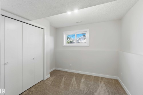 Neutral-toned carpeting complements the light gray walls - 119 Dorchester Drive, St. Albert, AB - Indoor Photo Showing Other Room