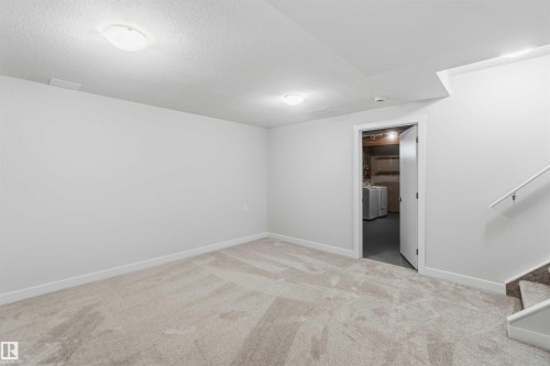 Carpeted room featuring white walls, ceiling-mounted lighting, and baseboard trim - 119 Dorchester Drive, St. Albert, AB - Indoor Photo Showing Other Room