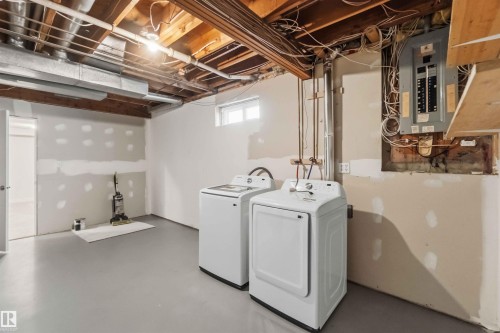 Utility area featuring a washer and dryer, exposed ceiling joists, and a window - 119 Dorchester Drive, St. Albert, AB - Indoor Photo Showing Other Room