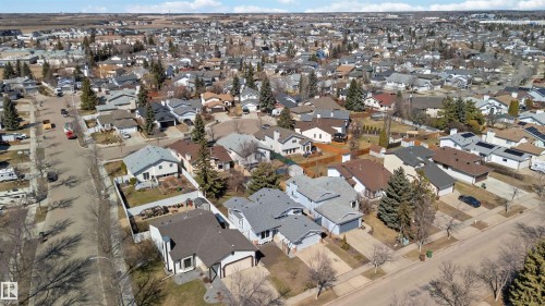 Suburban neighborhood featuring varied residential architecture, established streetscapes, mature trees, and a clear sky backdrop - 119 Dorchester Drive, St. Albert, AB - Outdoor With View