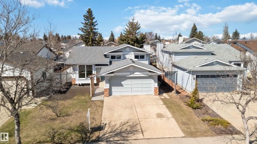 Light gray siding exterior with a dark gray shingled roof - 119 Dorchester Drive, St. Albert, AB - Outdoor With Facade