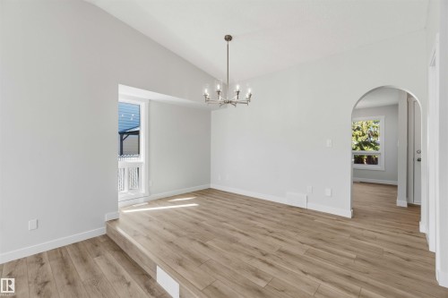 Spacious room featuring vaulted ceilings, light wood-finish flooring, and crisp white baseboards - 119 Dorchester Drive, St. Albert, AB - Indoor Photo Showing Other Room