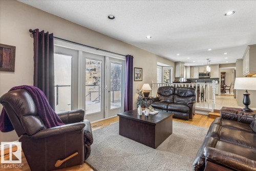 The living area features hardwood floors and recessed lighting, with a view into the kitchen area - 954 Rice Road, Edmonton, AB - Indoor Photo Showing Living Room