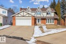 The property features a brick exterior with decorative timber accents, a double-car garage, and a concrete driveway - 954 Rice Road, Edmonton, AB  - Outdoor With Facade 