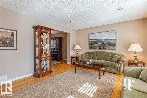 This living area features light hardwood flooring, a neutral wall color, and recessed lighting - 954 Rice Road, Edmonton, AB - Indoor Photo Showing Living Room